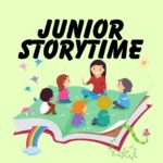 junior storytime lady sitting on a open book with children